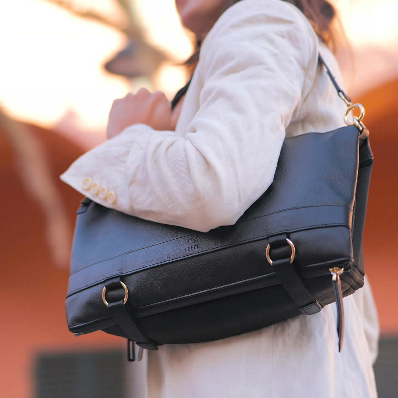 Woman with the DAKOTA black convertible handbag